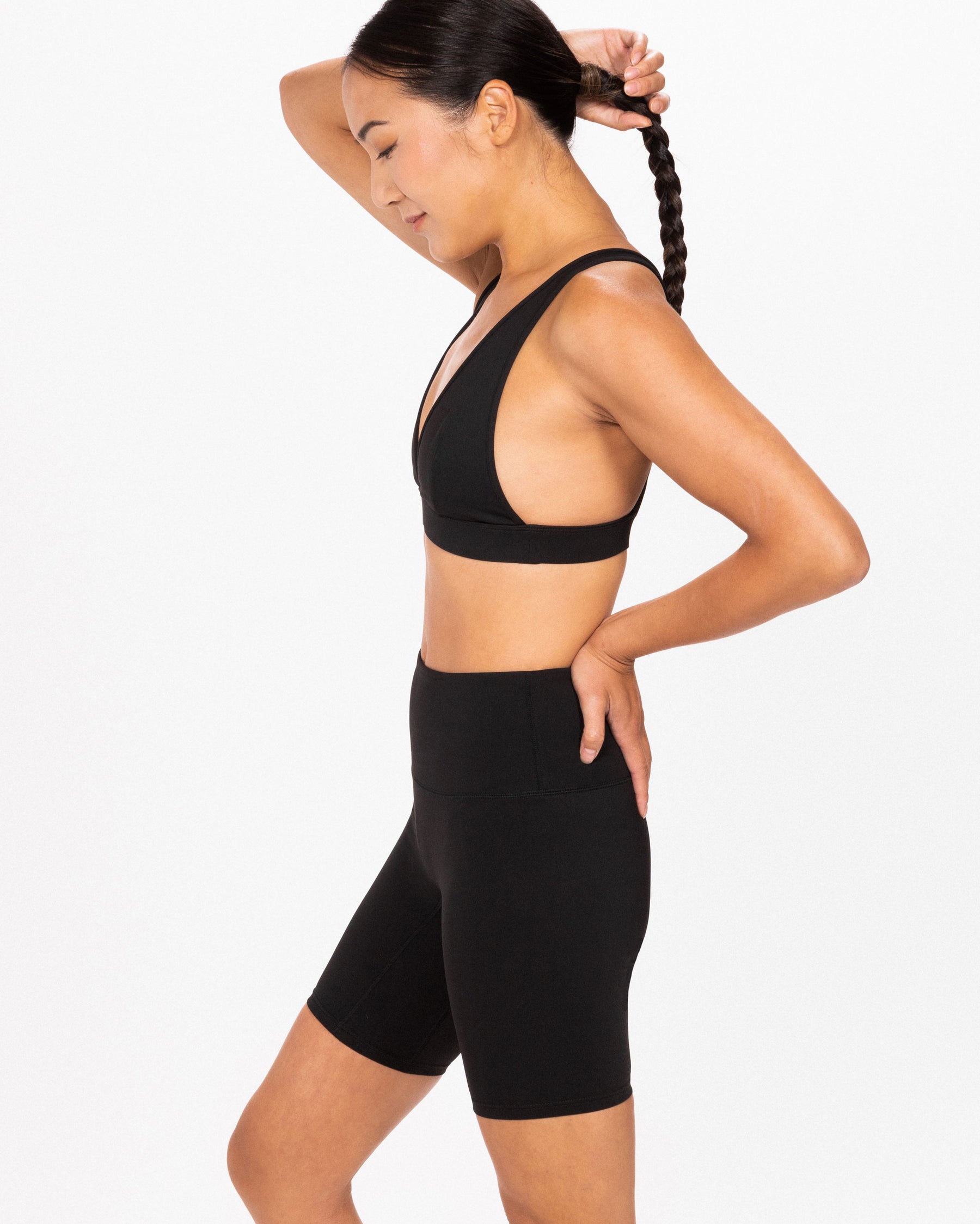 woman wearing deep v neck sports bra from an asian woman founded company