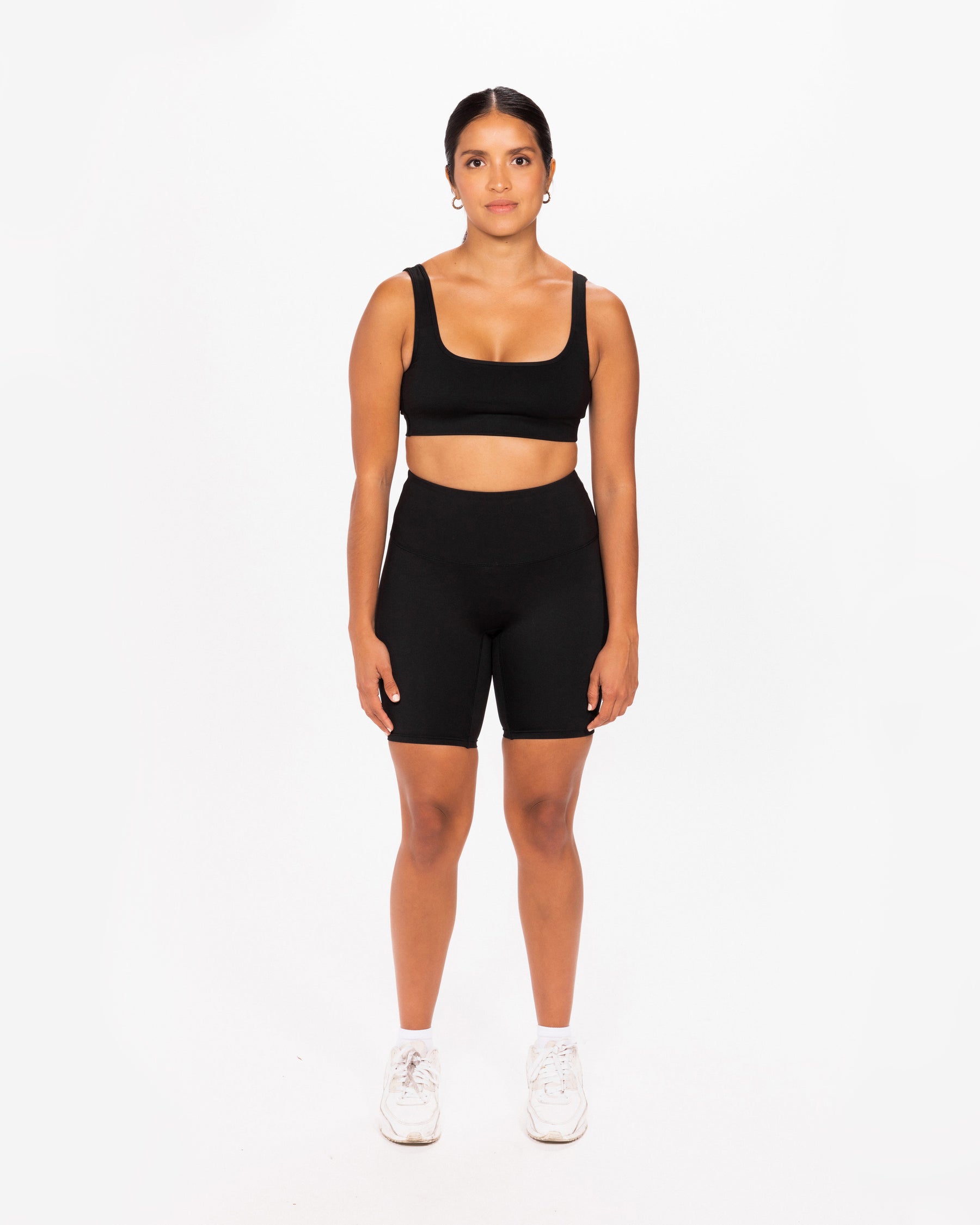Women wearing a full black lounge set made locally in Vancouver with white sneakers