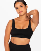 woman wearing Canadian brand black sports bra with removable padding 