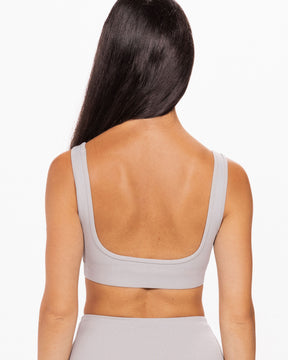 woman wearing grey bra with low back