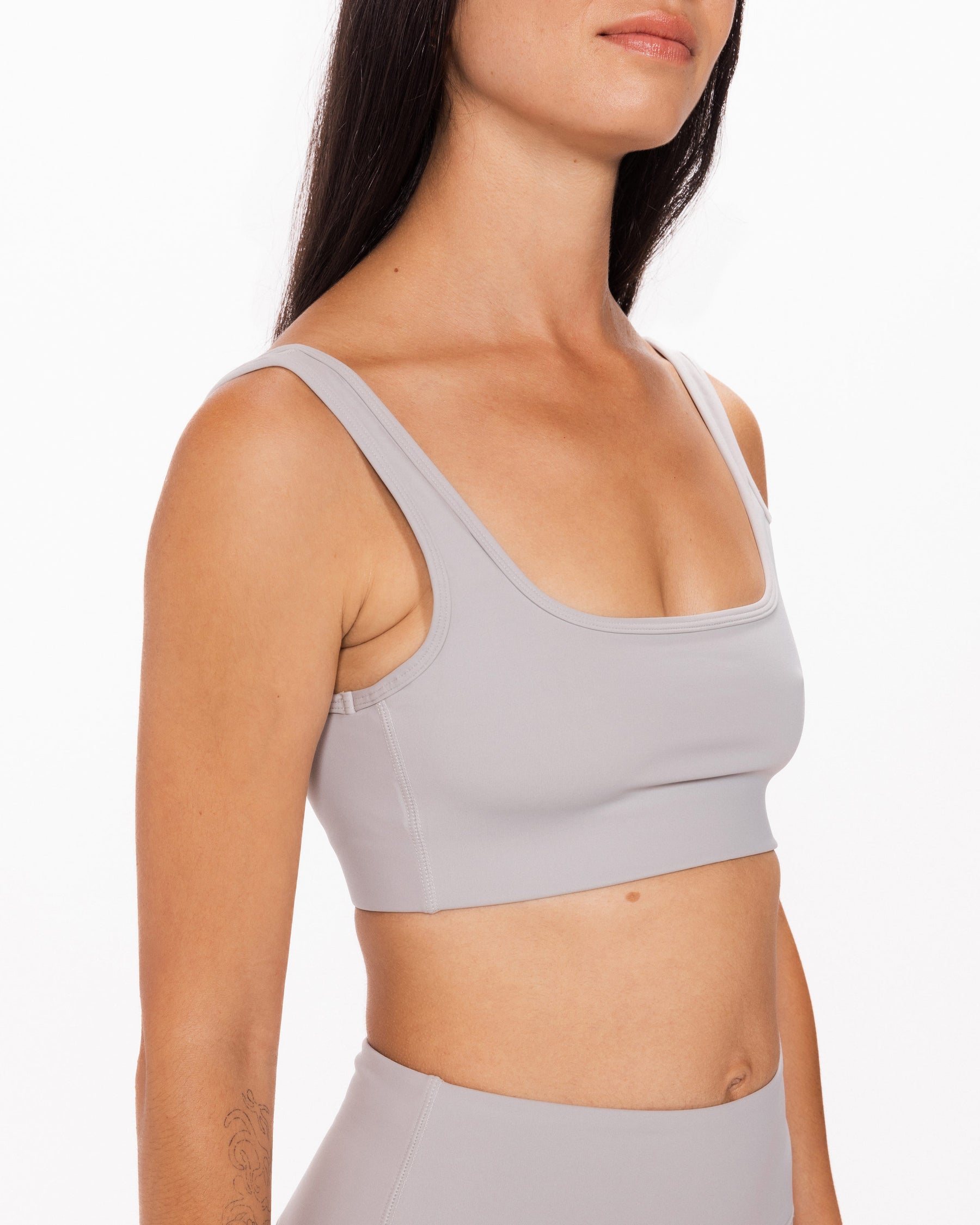 woman wearing grey sports bra with removable padding